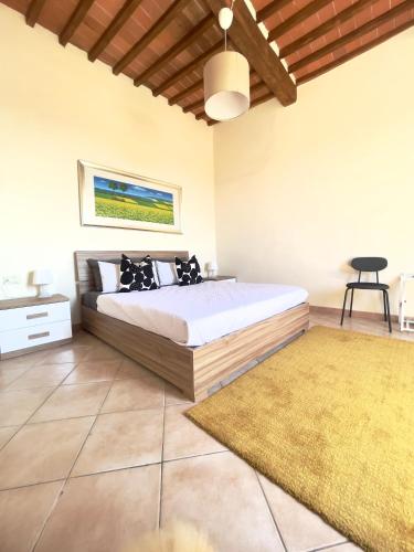 a bedroom with a bed and a rug at Il Borghetto - Fucecchio, Firenze in Fucecchio