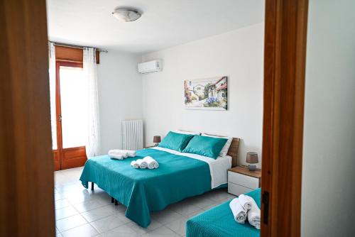 a bedroom with two beds and a window at San Lorenzo in Mesagne