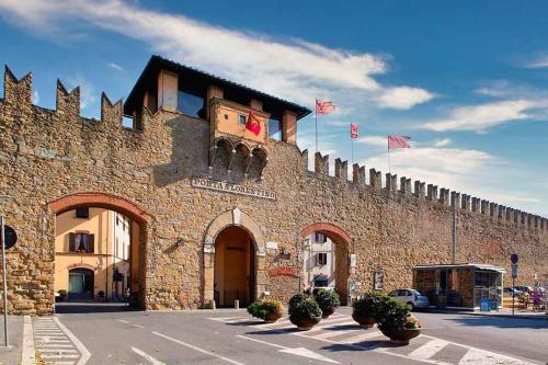 a large brick building with flags on top of it at La Terrazza di Emy, Arezzo - affitto turistico in Arezzo