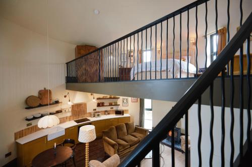 a room with a staircase and a living room at The Grain Store in Sutton Bonington