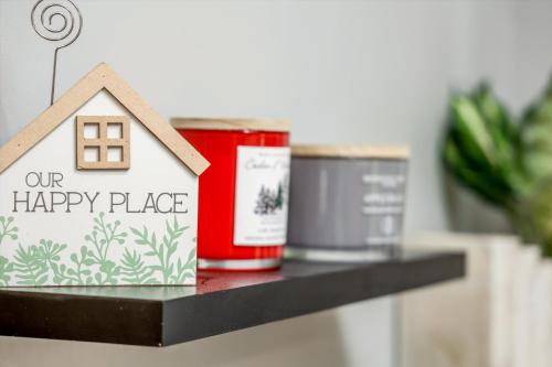 a small house on a shelf with a happy place sign at Comfy Modern and Cozy Queen Beds Free Parking in Detroit