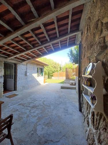 an entrance to a stone building with an open doorway at As Casinhas de Santo Ovidio in Fafe
