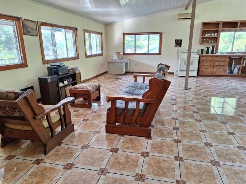a large living room with chairs and a table at Casa Tahoe Home Stay Playa Pita, Costa Rica in Tarcoles
