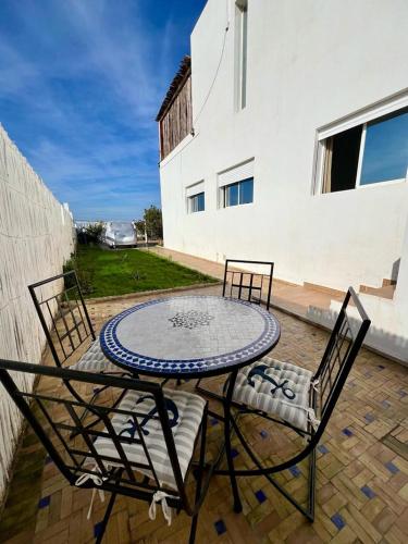 a table and two chairs on a patio at Dar Zouina 1 et 2 in Briech