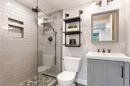 a bathroom with a toilet and a sink and a shower at Piedmont Park Pool-Side Retreat in Atlanta