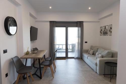 a living room with a couch and a table at Aegeans Eye in Azolimnos