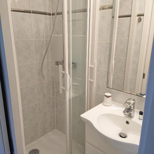 La salle de bains est pourvue d'une douche et d'un lavabo. dans l'établissement Le Parc aux Huîtres, à Cayeux-sur-Mer