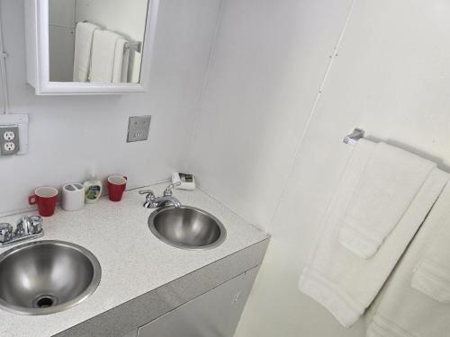 a bathroom with a sink and a mirror at Blue River Campgrounds & Cabin-public washroom in Blue River