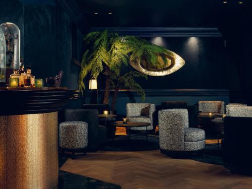 a bar with an elephant head on the wall at La Butte aux Bois a Small Luxury Hotel of the World in Lanaken