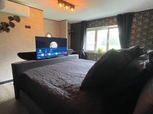 a bedroom with a bed with a laptop on it at Tranquilo Maaseik in Maaseik
