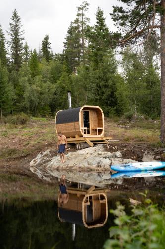 a couple of people standing in the water next to a boat at Vidsyn Midjås in Vistad