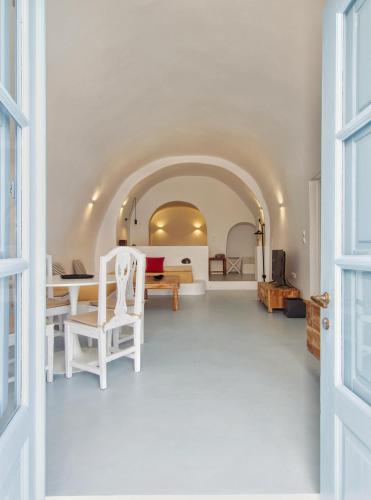 a room with a hallway with a table and chairs at Karpimo Scenery in Firostefani