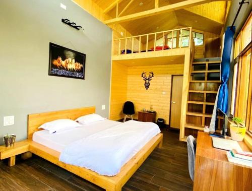 a bedroom with a bed and a loft bed and a desk at Lacasa Luxury Stays in Shogi