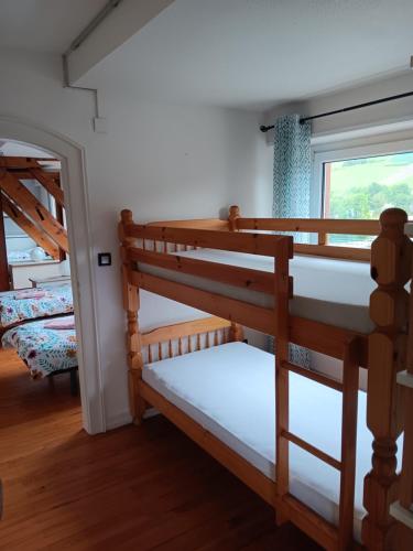 two bunk beds in a room with a window at Superbe gite au centre de Kaysersberg avec 3 chambres in Kaysersberg