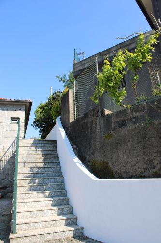 a set of stairs leading up to a building at As Casinhas de Santo Ovidio in Fafe