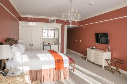 a bedroom with a large bed and a tv at The Bruce Hotel in Stratford