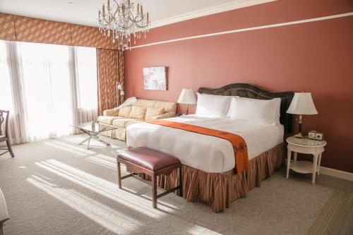 a large bedroom with a large bed and a couch at The Bruce Hotel in Stratford
