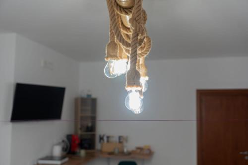 a group of lights hanging from a ceiling in a room at Stanze di Puglia in Sannicandro di Bari