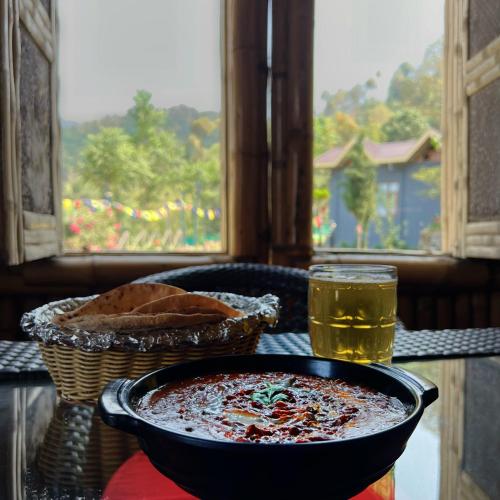 a table with a bowl of food and a glass of beer at Lacasa Luxury Stays in Shogi