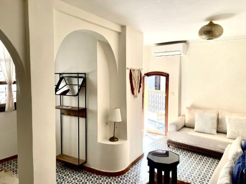 a living room with a couch and a table at DAR MUKTAB in Chefchaouene