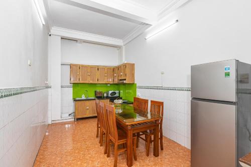 a kitchen with a table and a refrigerator at Quite Room In Old Quarter with Netflix and Free Laundry 4thFloor in Hanoi