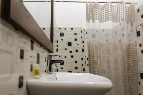 a bathroom with a sink and a shower at Xotic Resort Upper Floor in Kurunegala