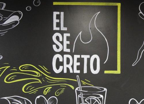 a drawing of a sign with a glass of coffee at Hostal el secreto in Teruel