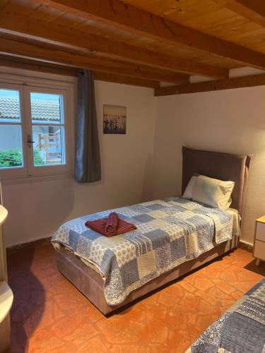 a bedroom with a bed with a towel on it at Hamre Apartments (Nicholas) in Agios Georgios Pagon