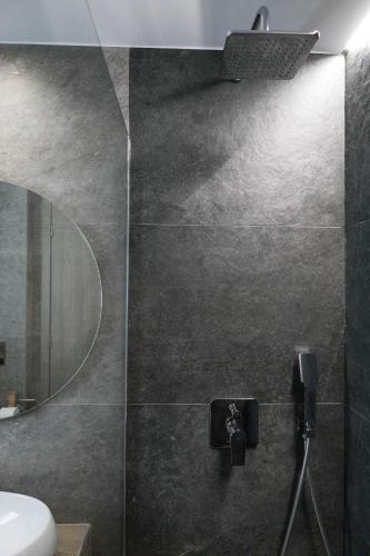 a bathroom with a shower and a sink and a mirror at Aegeans Eye in Azolimnos
