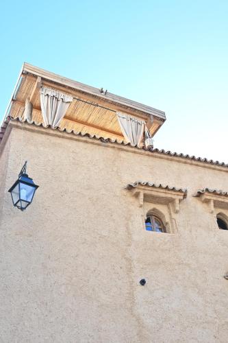 a building with a light on the side of it at DAR MUKTAB in Chefchaouene
