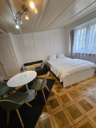 a bedroom with a bed and a table and chairs at City Center Apt. Old Town ZH in Zurich