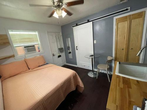a bedroom with a bed and a ceiling fan at Pao and Pui in Kenner