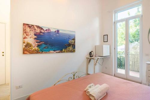 a bedroom with a bed and a view of the ocean at Beatrice Room Bed&Breakfast in Sant'Agnello