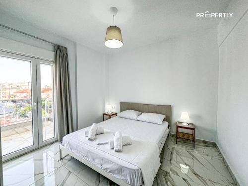 Ένα ή περισσότερα κρεβάτια σε δωμάτιο στο Ocean Pearl #PROPERTLY