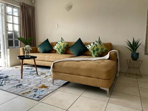 a living room with a couch and a table at Arabella By The Sea in Port Alfred
