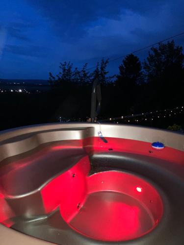 a red bath tub with a red light in it at Panoráma Nyaraló in Tahitótfalu