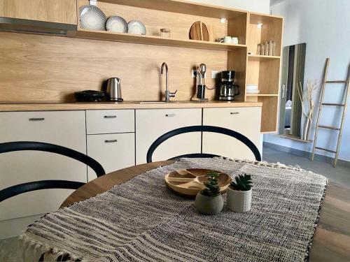 a kitchen with a table with a table cloth on it at Αura Luxury Apartments in Ierissos