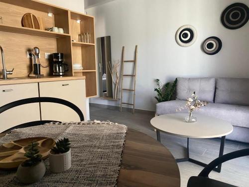 a living room with a couch and a table at Αura Luxury Apartments in Ierissos