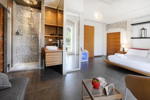 a bedroom with a bed and a bathroom at Itria Palace in Ragusa