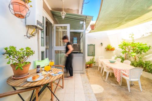 a person standing on a patio with a table at Pátio da Laranjeira in Tomar