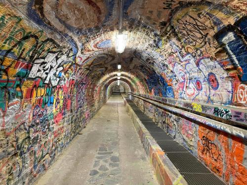 a tunnel with graffiti on the wall at Appartement avec vue exceptionnelle sur mer in Cerbère