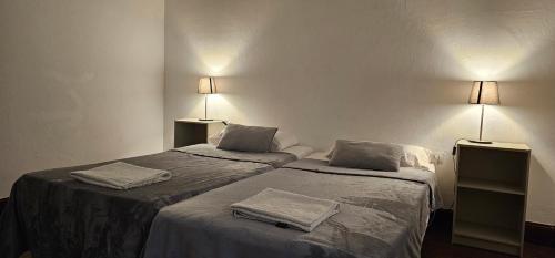 a room with two beds with towels on them at Casa Andrea in Las Palmas de Gran Canaria