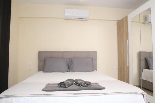 a bed with two pairs of shoes on it at Haris Studio 2 in Keramotí