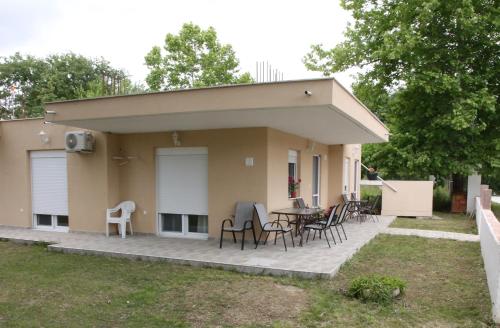 a house with a patio with chairs and a table at Haris Studio 2 in Keramotí