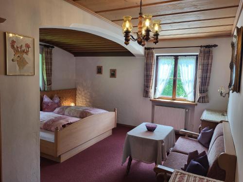 1 dormitorio con 1 cama y sala de estar en Villa Bergkristall, en Eschenlohe