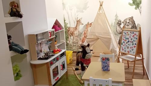 a play room with a toy refrigerator and a tent at Staro Chałpa in Istebna