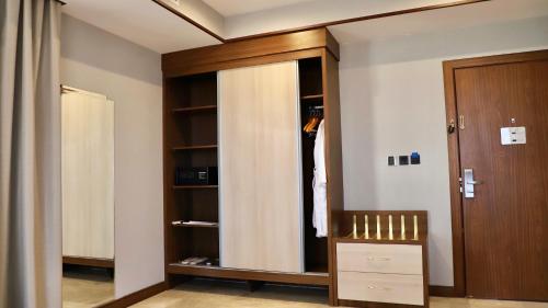 a room with a closet with a wooden door at Five Seasons Hotel in Tabuk