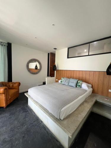a bedroom with a large bed and a couch at Hostel-Island Paradise, Saboga Lodge and Villa Noelia in Panama City