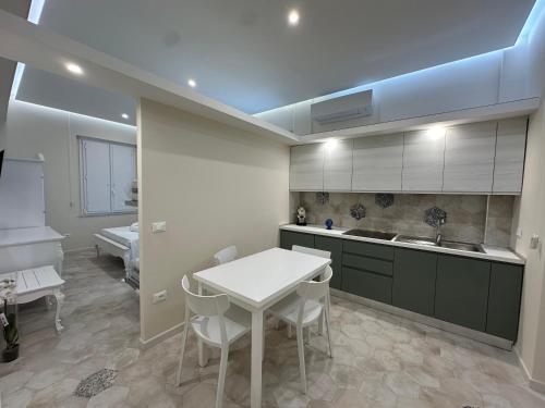 a kitchen with a table and chairs and a sink at b&b Giorgia in Tropea