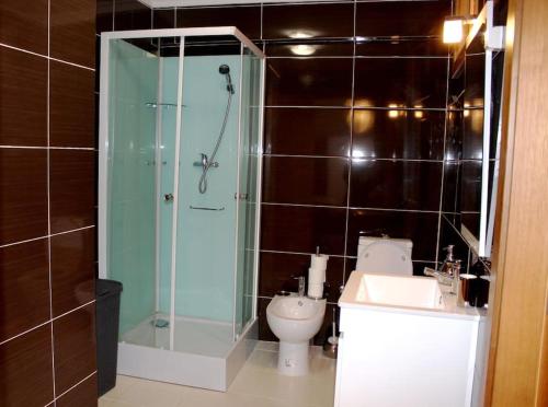 a bathroom with a glass shower and a toilet at Casa da Avo Maria - 2 in Podence